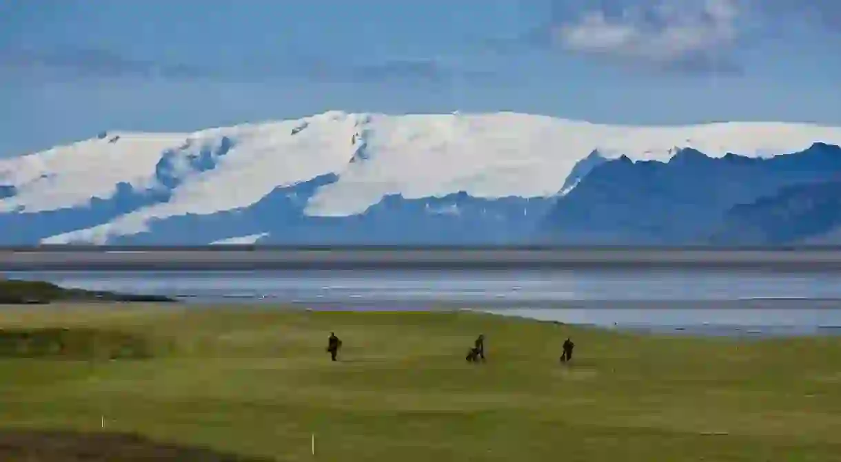 Golfers at Hornafjordur fjord, Iceland.