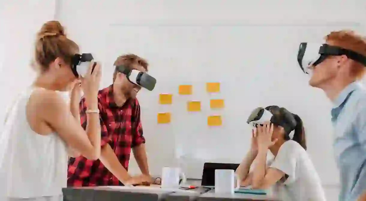 Developers with virtual reality simulators during a meeting