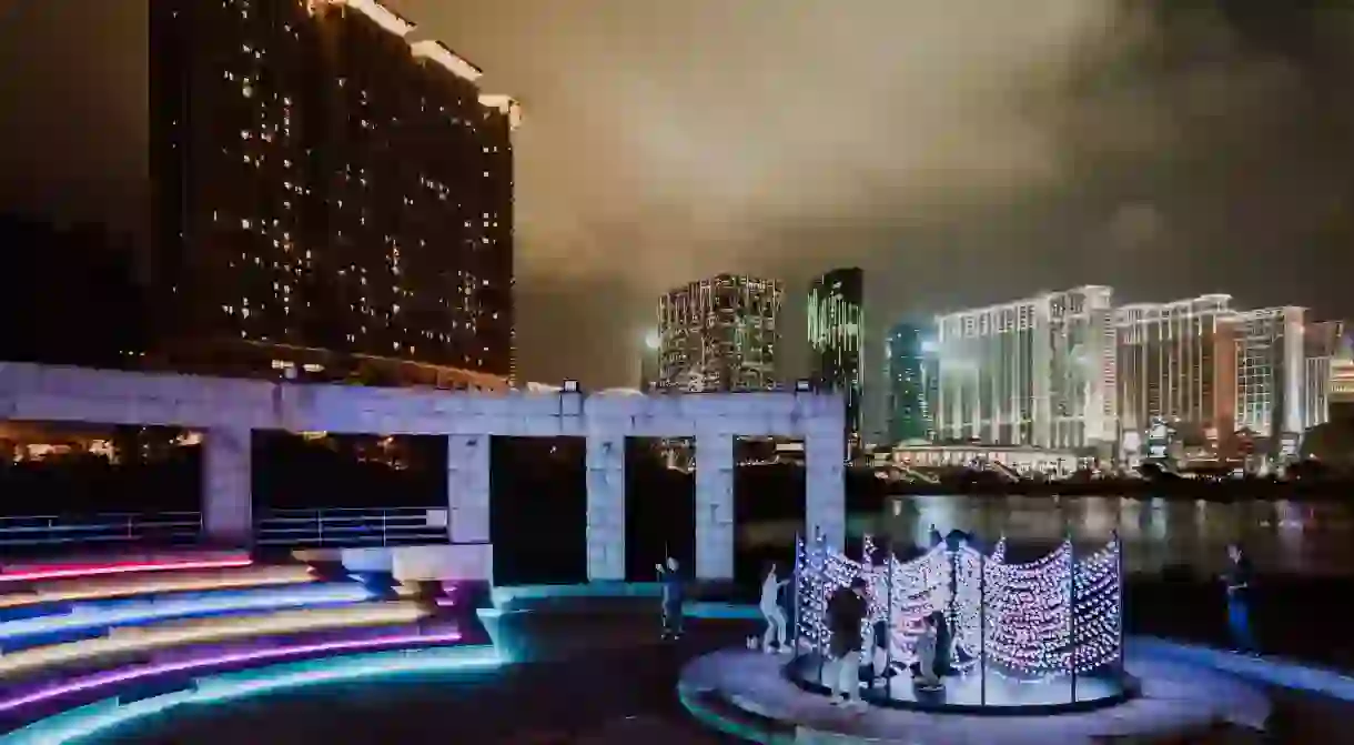 The ‘Colour Wave Tree’ reflects the shades of Macau’s neon-clad casinos in the background