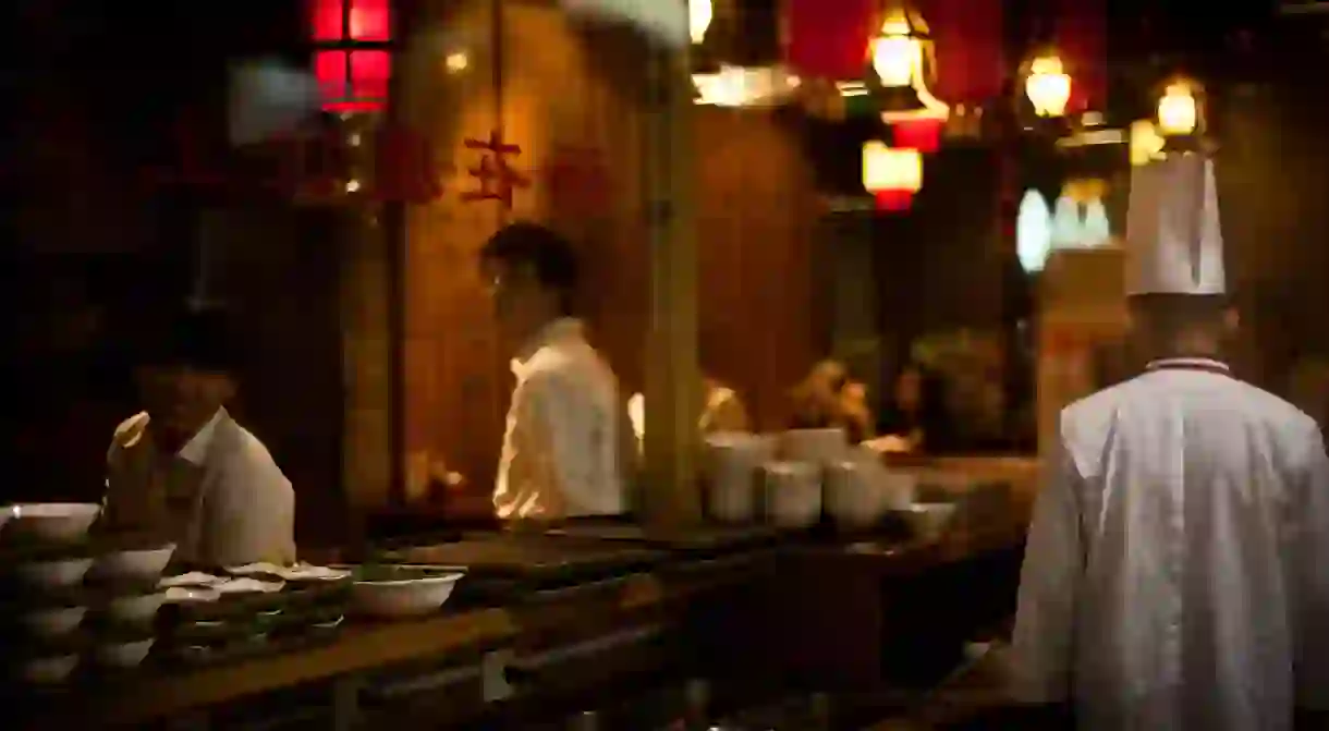 Waiters and the chef in a restaurant in Qianmen, Beijing