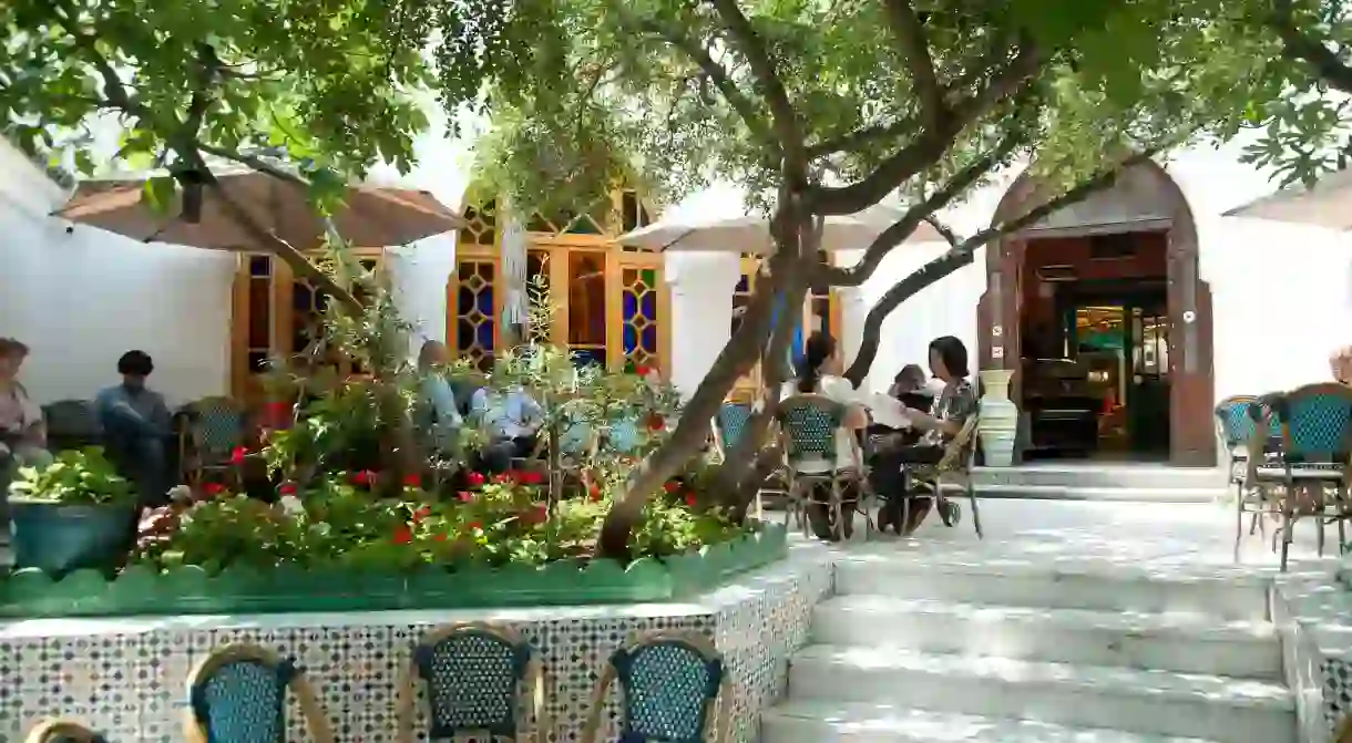 People relax in the beautiful courtyard of the Grande Mosquée de Paris