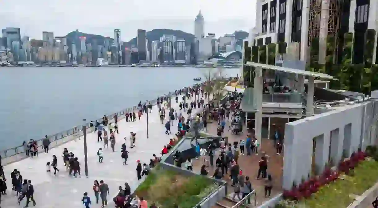 People walk up and down the Hong Kong Avenue of Stars at Tsim Sha Tsui’s Victoria Harbour