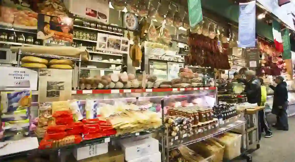 Shoppers place orders at a deli in Little Italy in the Bronx