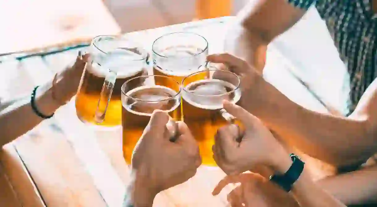 Group of friends drinking beer in a bar