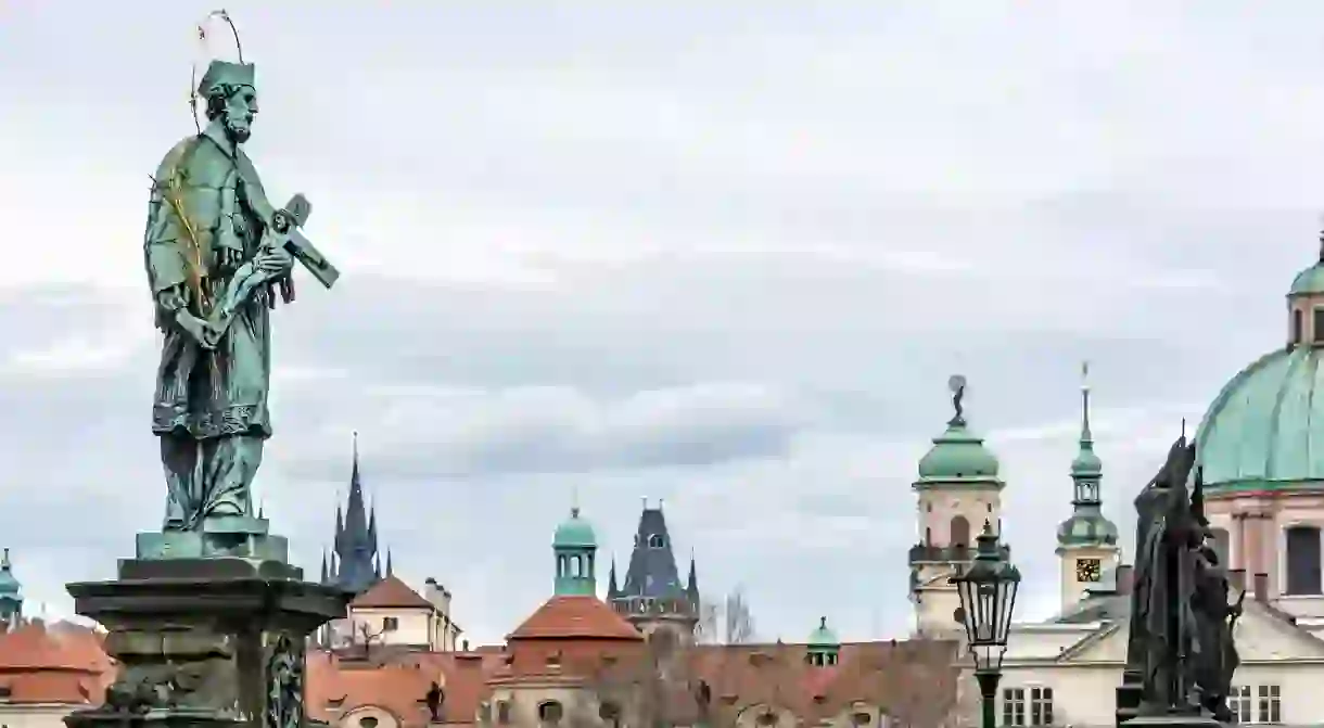 The Statue of St John of Nepomuk stands tall on the Charles Bridge