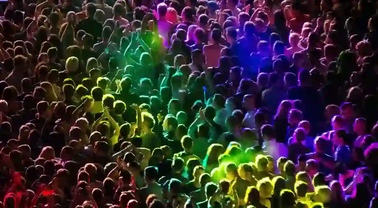 Rainbow colours wash over the crowd during a performance by All Saints at Manchester Pride in 2014