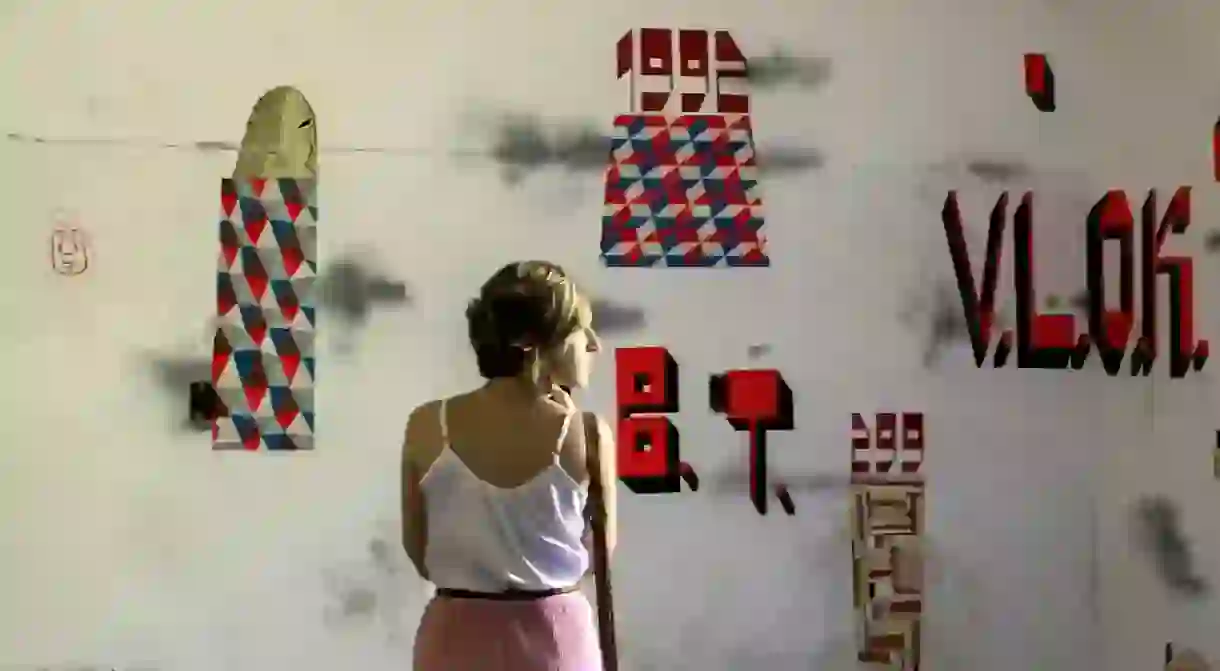 A woman looks at the artwork Black Hill by artist Barry McGee.