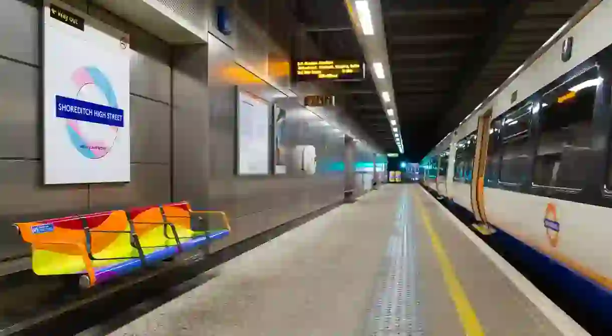 Coloured roundels and benches at Shoreditch High Street station for Pride