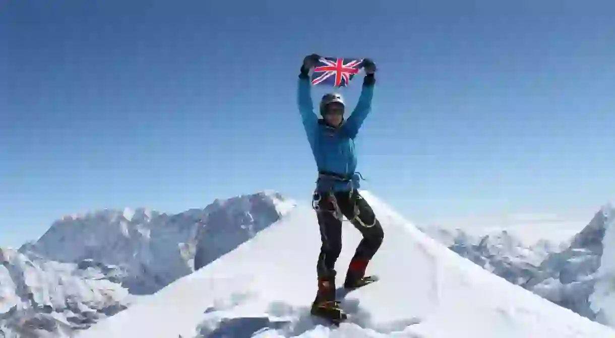 Bonita Norris waves the Union Jack at the summit of Ama Dablam in November 2011