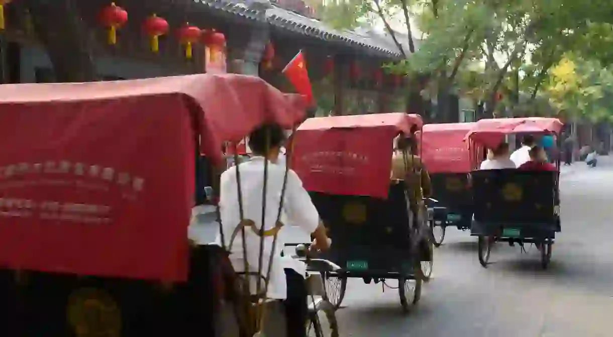 Pedicabs travel down the street in Shichahai, Beijing, China