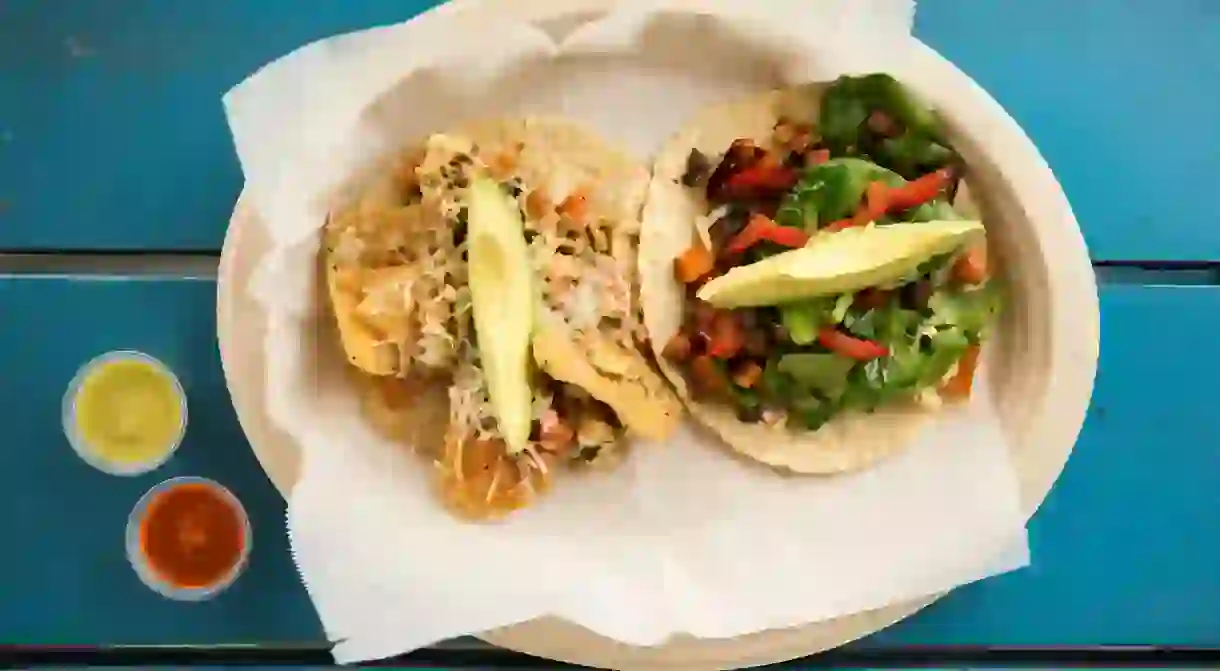 Tacos with eggs, spinach, carrots, mushrooms, bell pepper, tortilla chips, avocado, cheese and pico de gallo.