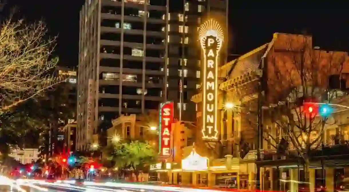 Cars stream along Congress Avenue in downtown Austin