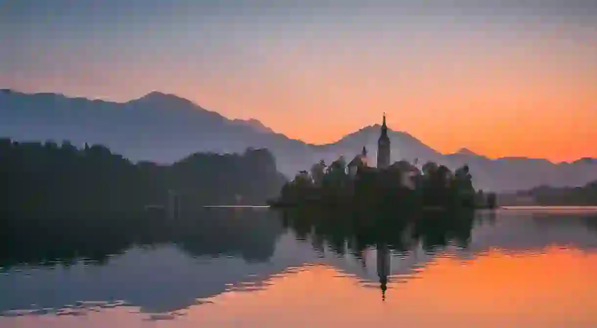 Little Island with Catholic Church in Bled Lake, Slovenia at sunrise.