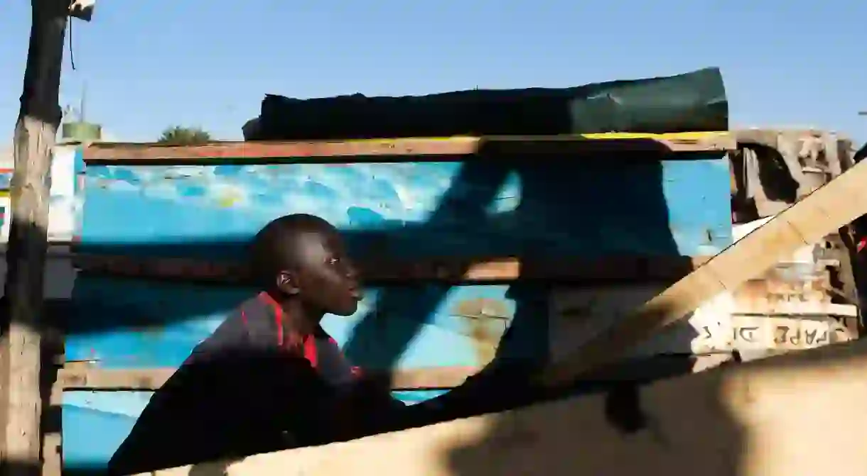 12-year-old Alioune helps his father, master carpenter Mbaye Gningue, build a pirogue in Dakar