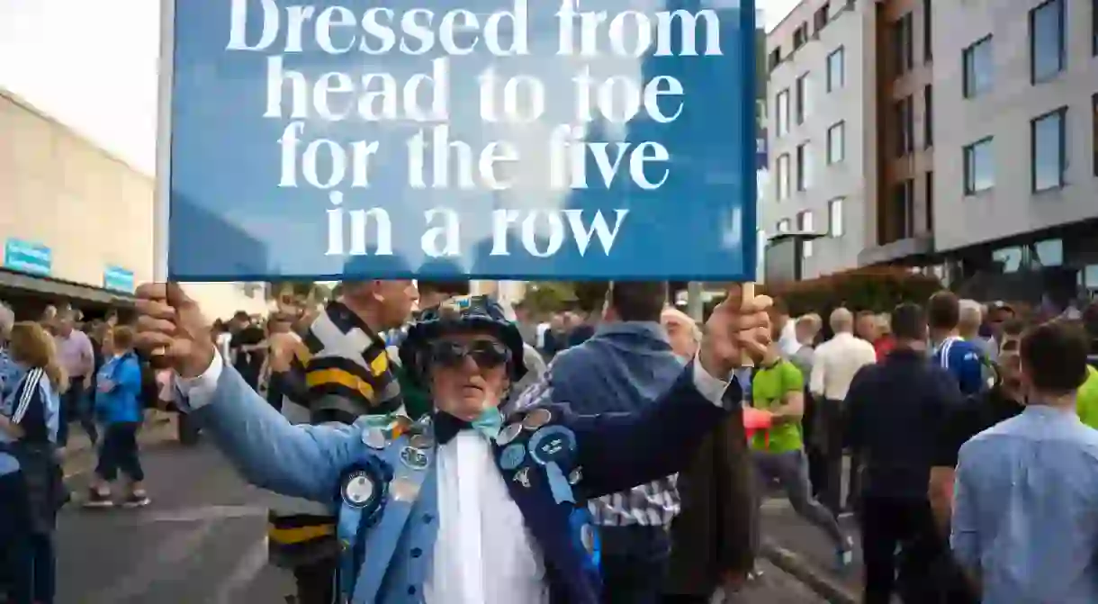 A Dublin Gaelic football fan waves a flag with messages in support of the team, outside Croke Park stadium on the day of the All-Ireland finals on September 14, 2019