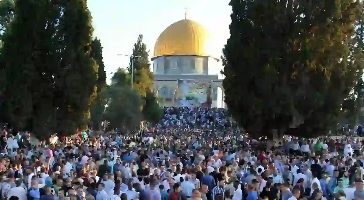 Palestinian Muslims after performing the morning Eid al-Fitr prayer near the Dome of Rock at the Al-Aqsa Mosque compound, Islams third most holy site, in the Old City of Jerusalem