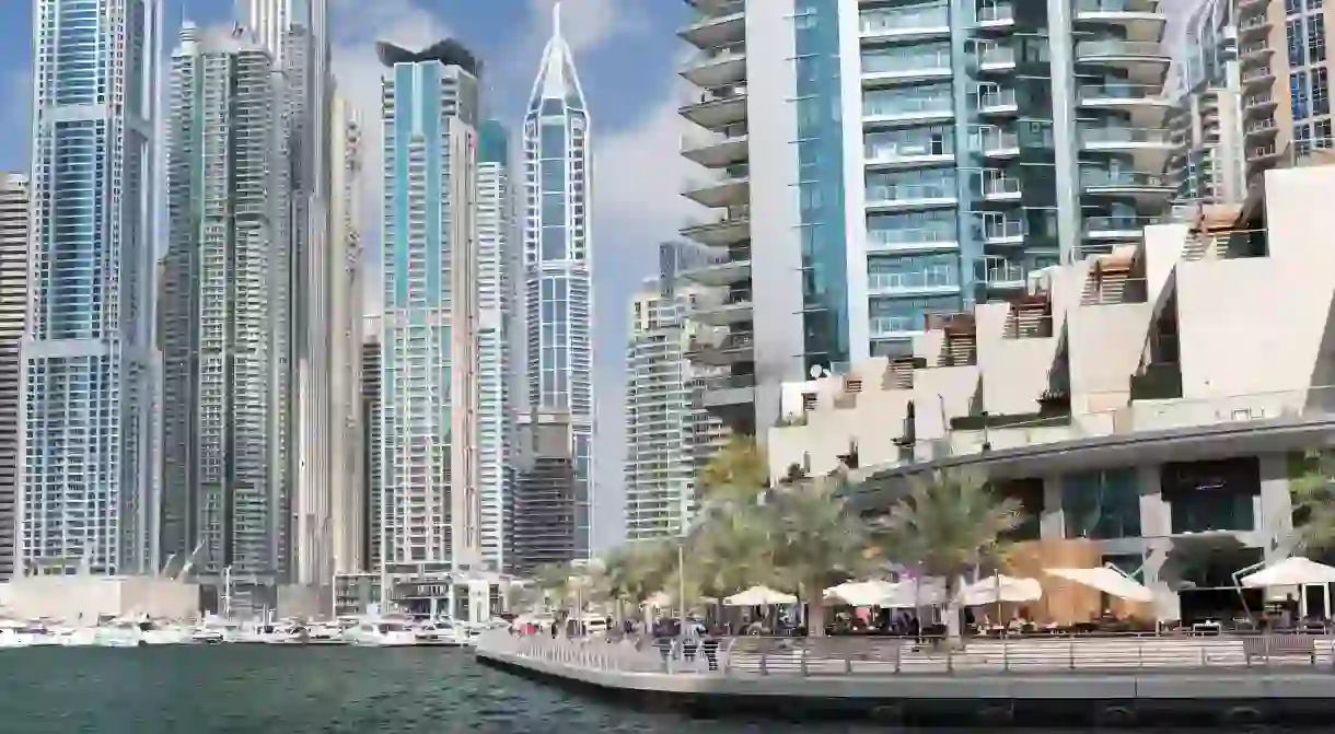 Cafés and restaurants along the Dubai Marina waterfront walkway.