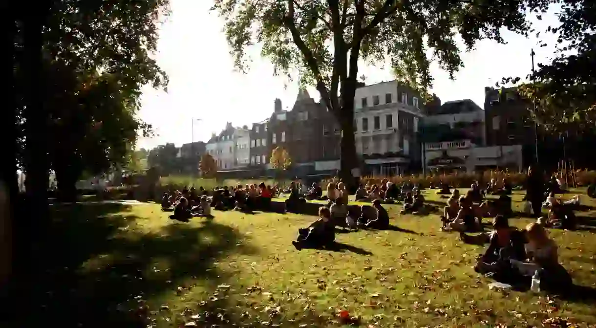 A Sunday crowd enjoys the late afternoon sun on Islington Green