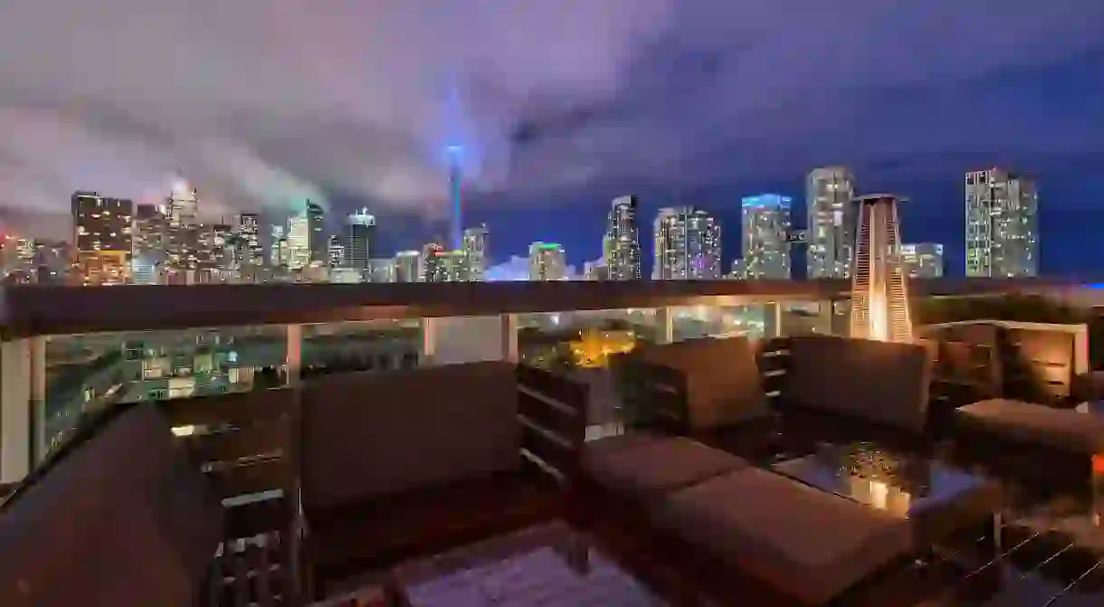 The Toronto skyline at dusk can be viewed from the terrace of the Thompson hotel