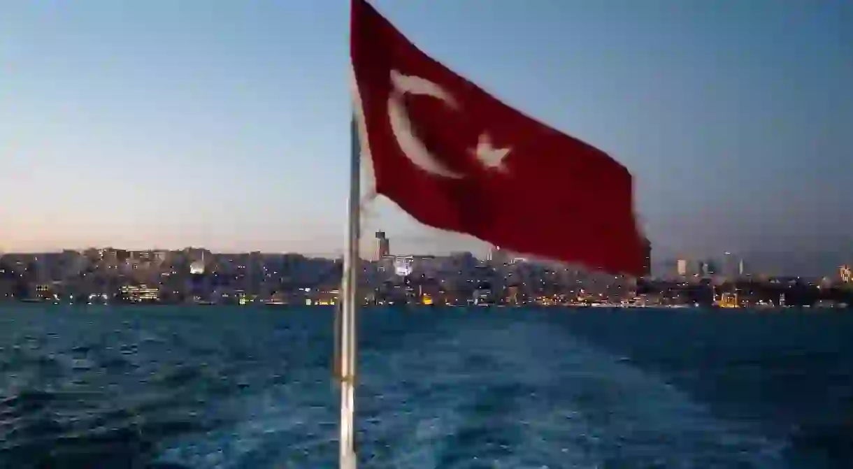 The Turkish flag flies over the Bosporus on the back of a ferry