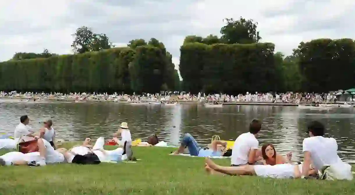 French people lounge under a cloudy Bastille Day sky