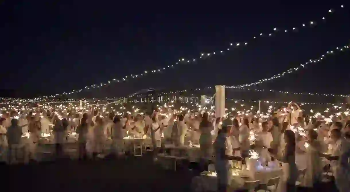 Participants in 2018’s Diner en Blanc light up the night with sparklers