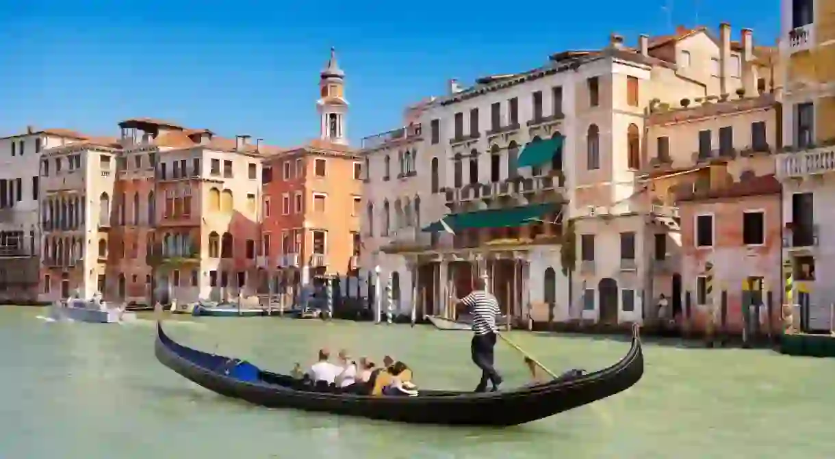 A gondola ferries tourists along the magnificent Grand Canal in Venice