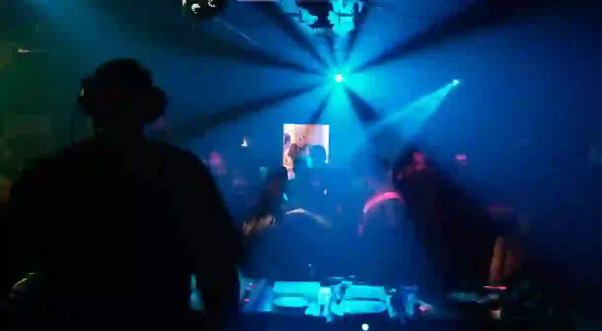 DJ Playing a Set in a Crowded Nightclub