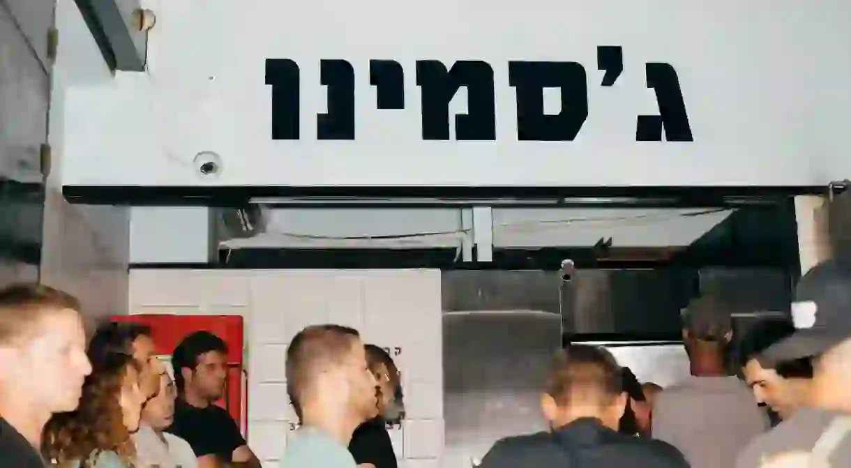 ISRAEL, Tel Aviv-Jaffa - Customers wait in line at the local food stall Jasmino, known for different meats served in Pita bread, on Allenby Street in the center of Tel Aviv, also known as Lev Hair, Hebrew for Heart of the City, on Thursday, September 12, 2019. Tel Aviv-Jaffa, also called “The City That Never Sleeps”, is the second largest city in Israel with the largest metropolitan area. It is a rapidly growing city in the midst of a transition from medium-sized urban center to bustling international metropolis. Tel Aviv is known for it’s beach life and a population that spends plenty of time on physical and outdoor activities. (Jonas Opperskalski / laif)