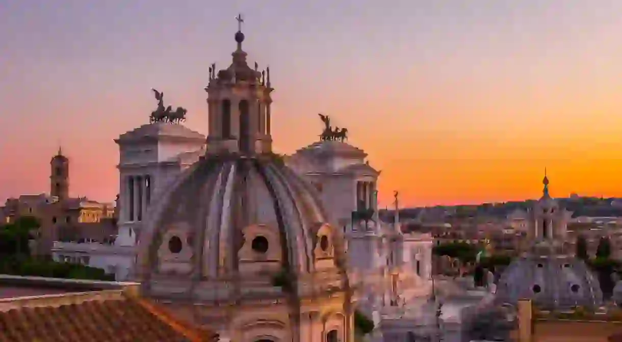 Sunsets in Rome tinge the historical architecture in the city in a warm orange light