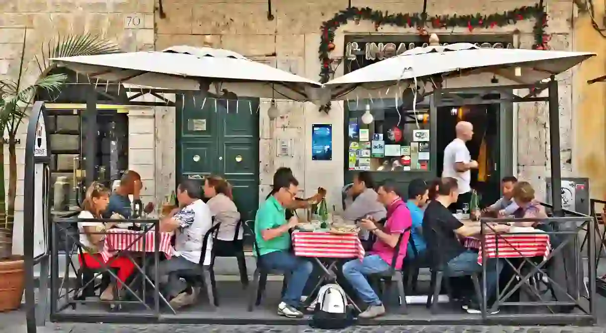 Diners enjoy an al fresco meal on the historic streets of Rome