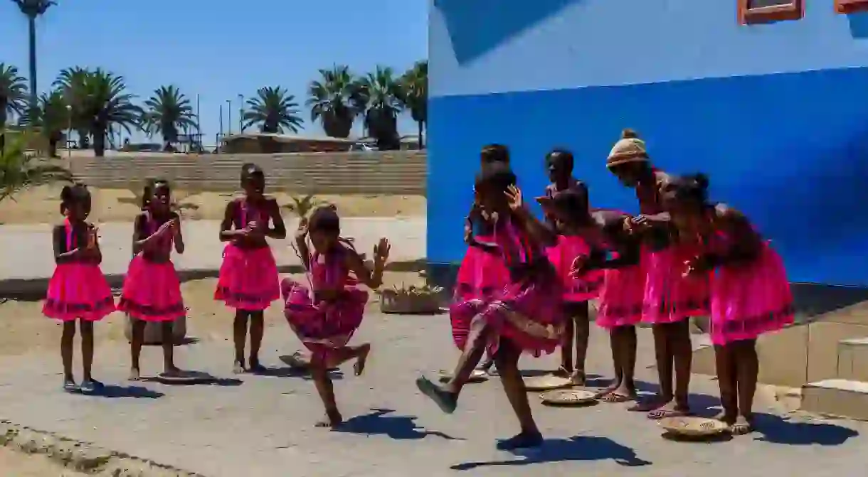 Girls perform song and dance routine outside local school in Swakopmund