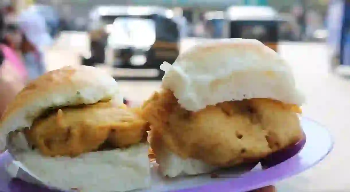 The Street Food That Defines Mumbai. ... A pillowy pav, stuffed with a golden-fried spiced batata (potato) vada, covered with a lick of tamarind and coriander chutneys