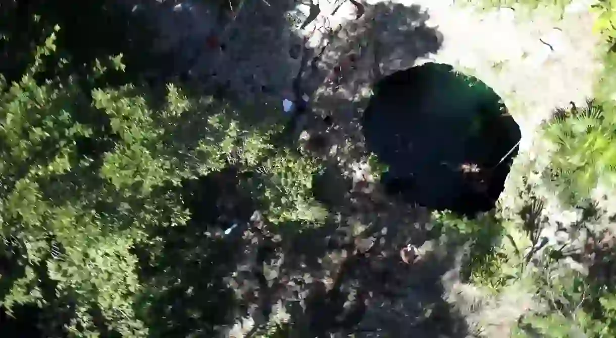 The Cenote Calavera in Tulum, Mexico is a sinkhole filled with water