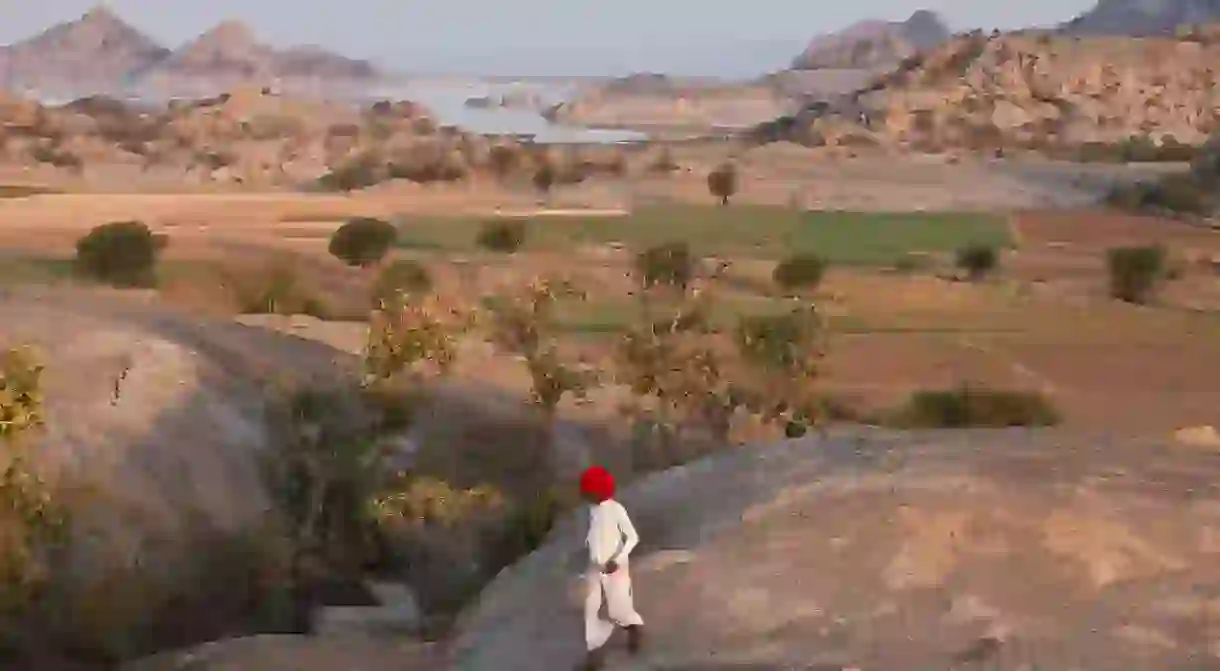 A Raika shepherd searches for a lost lamb on the fringes of the Thar Desert