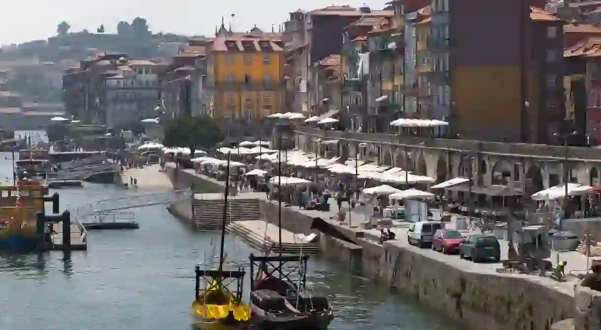 The Douro River flows past Ribeira in Porto, Portugal