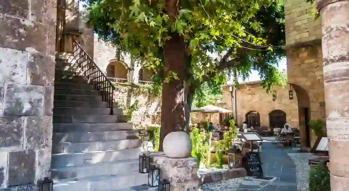 Enjoy a drink al fresco in the courtyard at Sissitio, in the Old Town of Rhodes