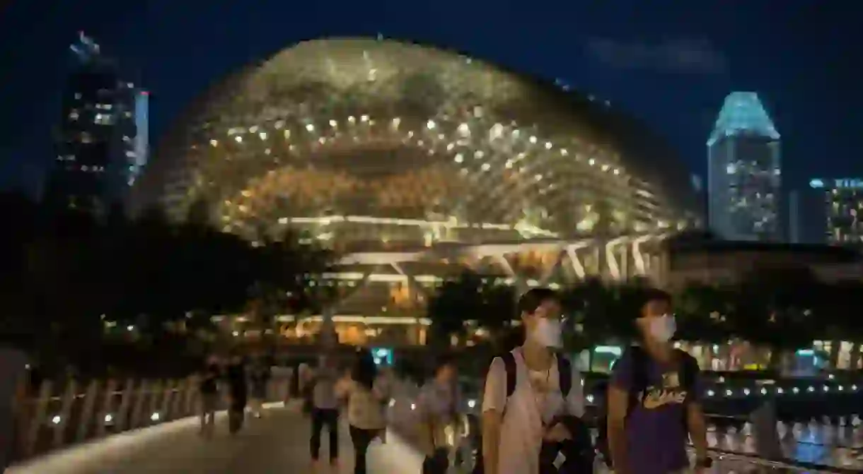 February the 12th, 2020. Small groups of people enjoying the coolness of the night near Singapore’s iconic Esplanade by Marina Bay