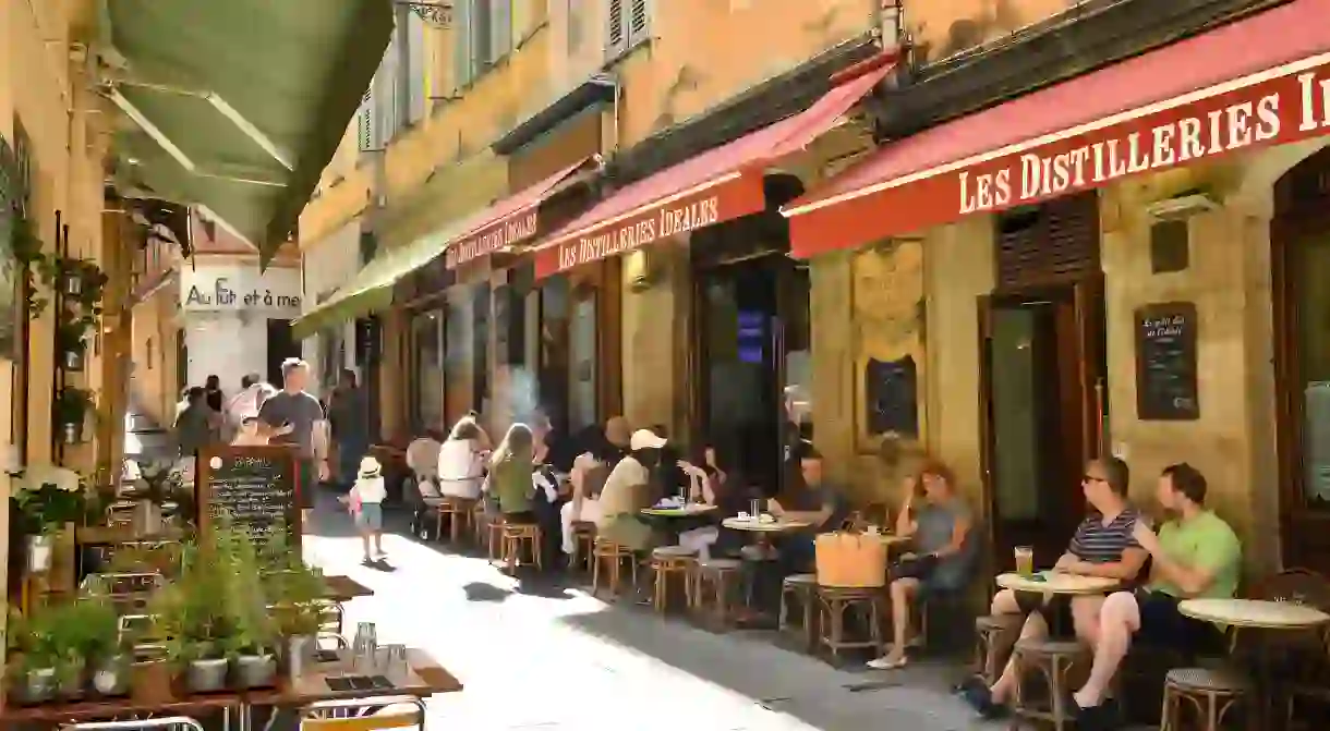 Enjoy a streetside drink at Les Distilleries Idéales