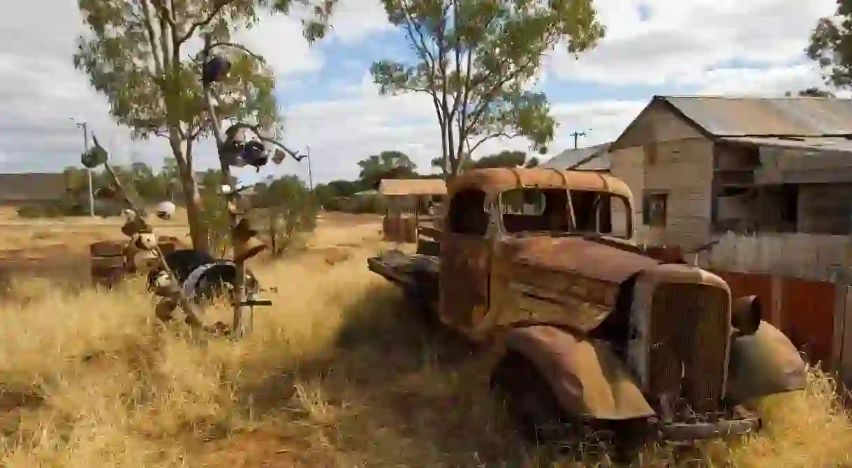 A rusted truck sits outside preserved miners cottages in Gwalia