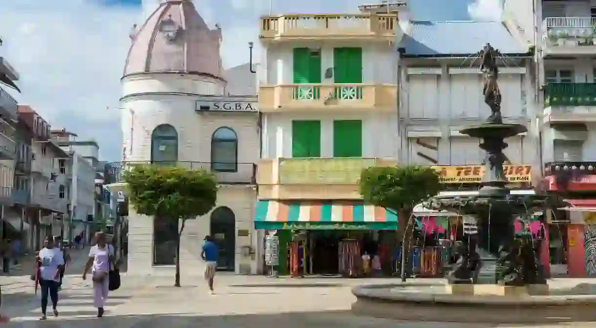 The Market Square in Pointe-à-Pitre is characterized by colorful shop awnings and 19th-century buildings