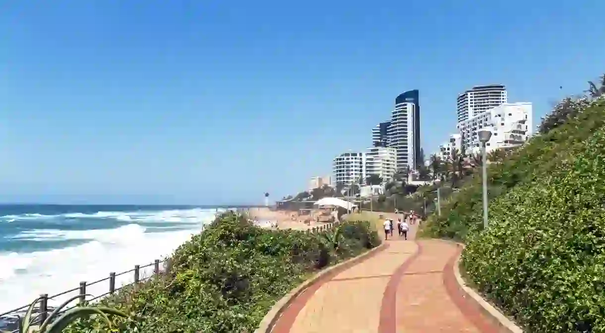 promenade on beachfront against coastal commercial and residential city skyline in Umhlanga