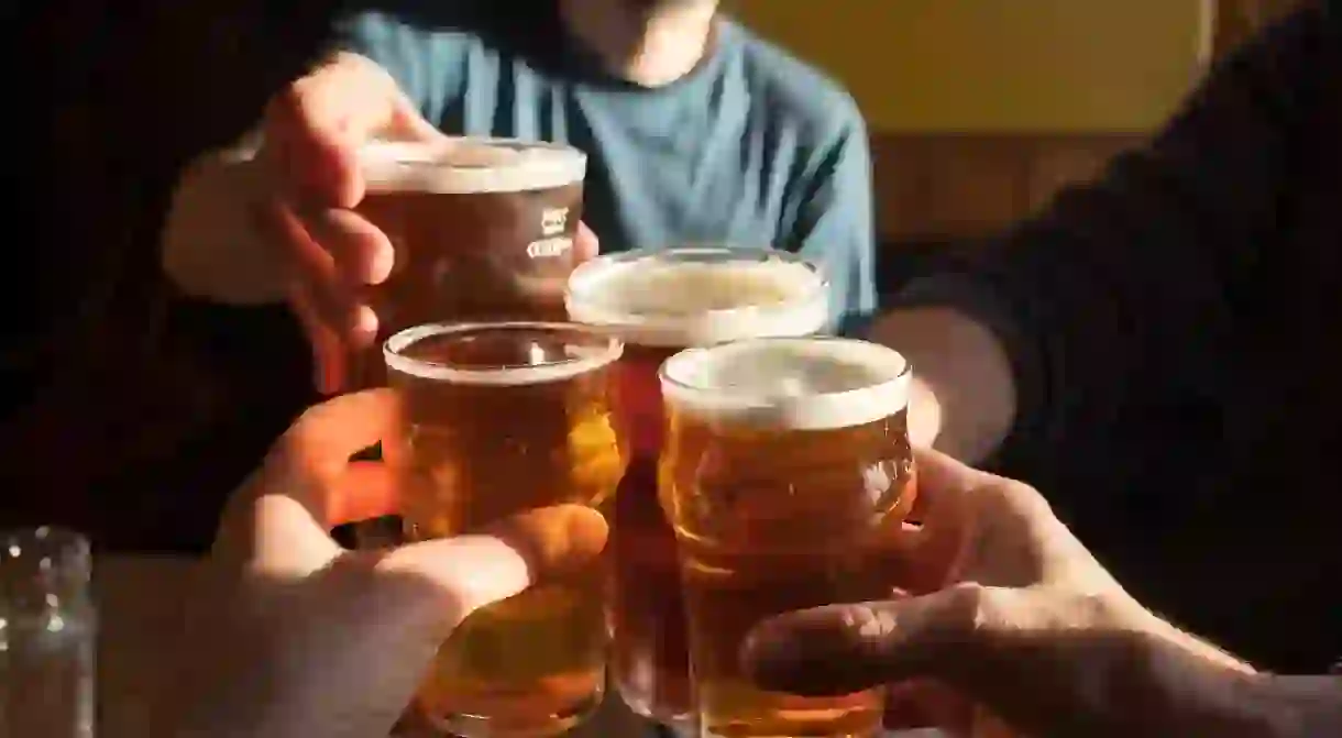 People drinking pints of beer