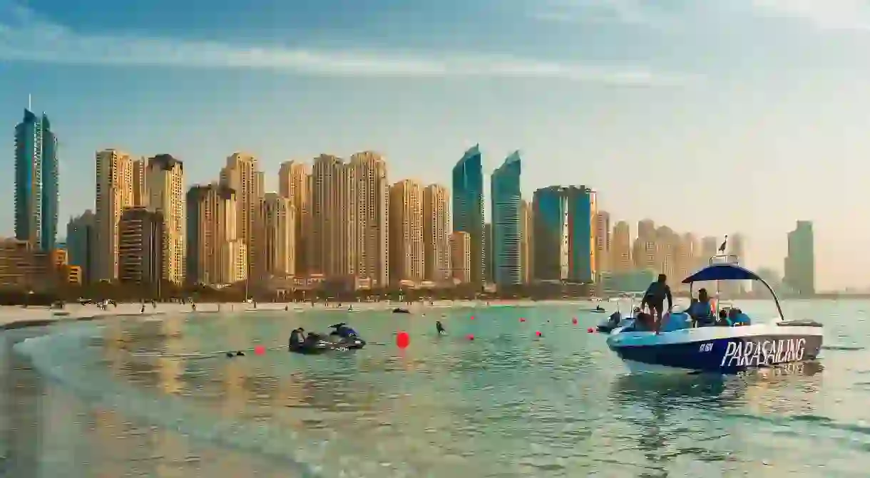 Soar above the luxury buildings of Jumeirah Beach Residence with a parasailing experience in Dubai