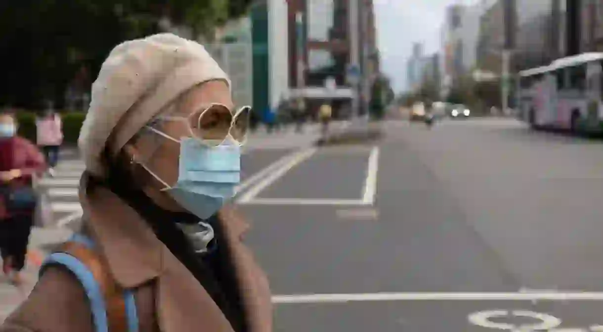 A woman wears a face mask to protect herself from the spread of coronavirus