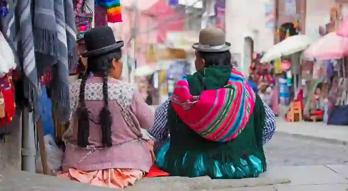 Cholita women from Bolivias indigenous Aymara tribe. The tradition of wearing bowler hats is thought to have started a century ago, when a shipment of the hats, sent to British railway workers who were stationed in the country, turned out to be too small