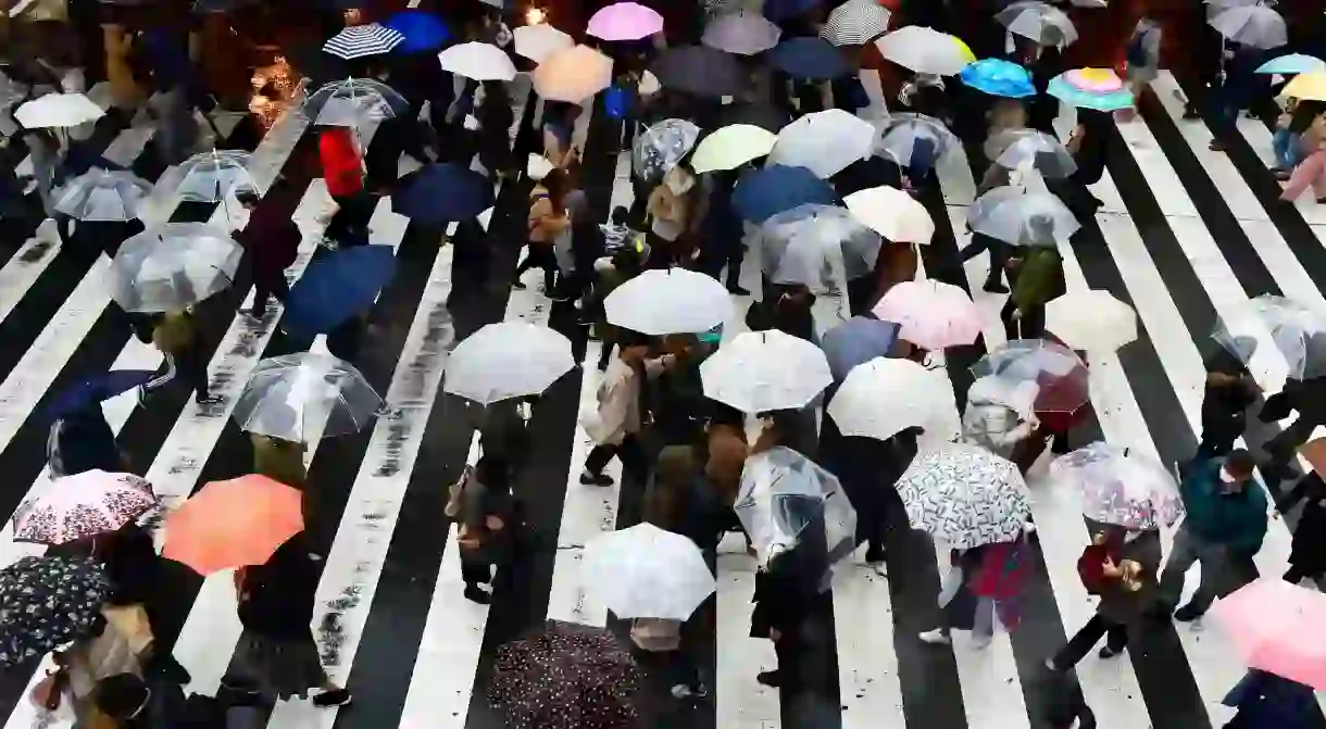 Pedestrians with multi colored umbrellas in Umeda district, Osaka, Japan.