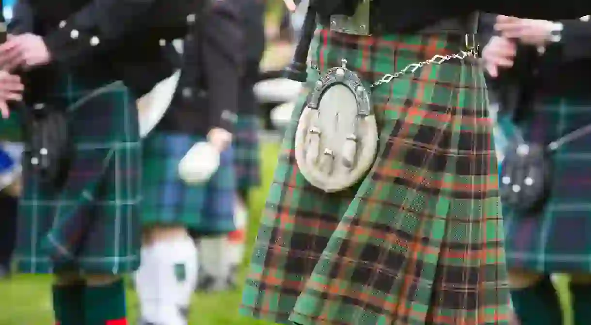 A detail of the kilts of a pipe band, Scotland.