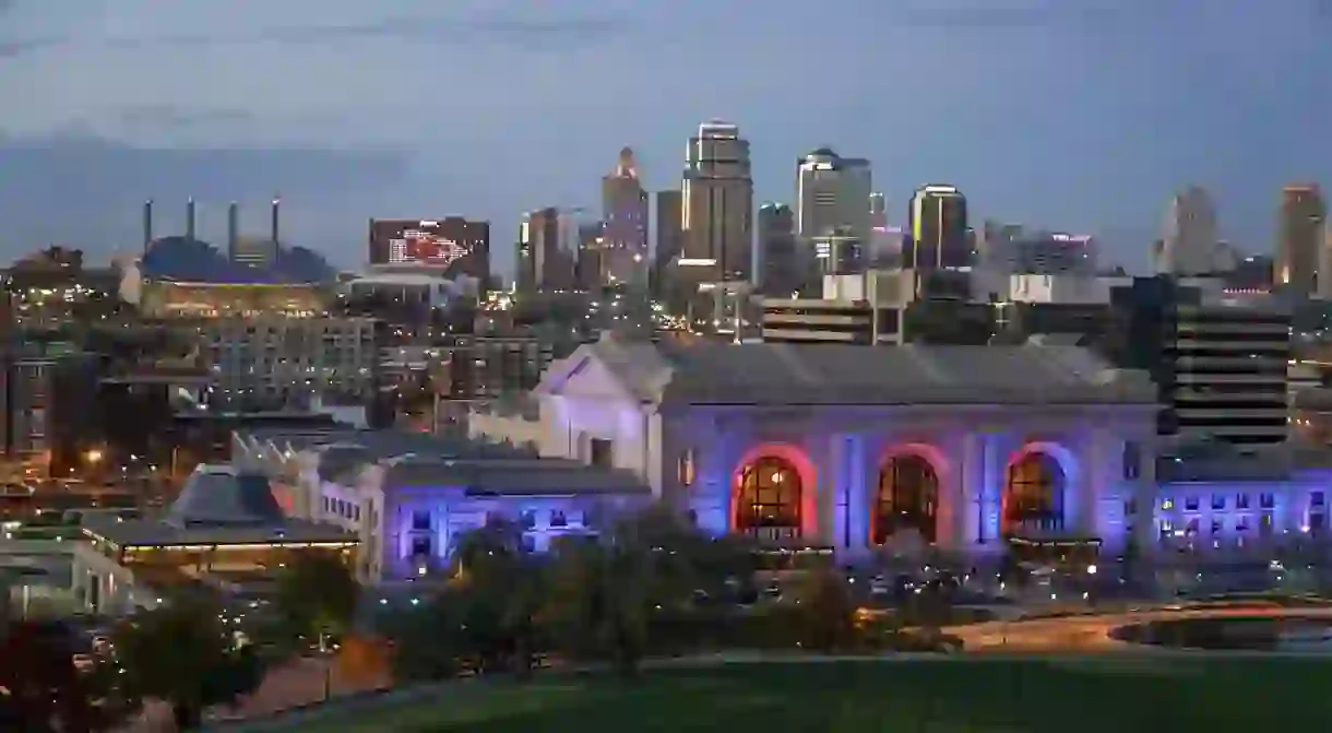 Union Station provides a splash of color against the Kansas City skyline at dusk