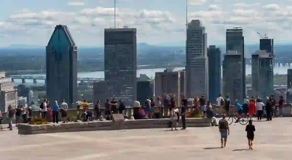 Tourists enjoying view of Montreal skyline from Kondiaronk Belvedere at Chalet du Mont-Royal